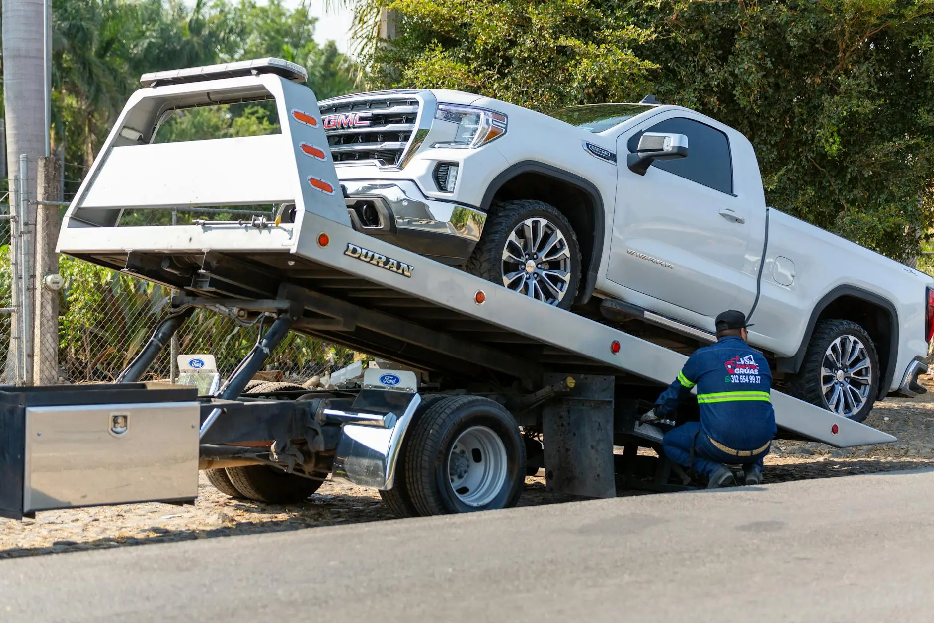 A clean, well-maintained DAD'S TOWING SERVICE LLC truck driving through a Westminster commercial district.